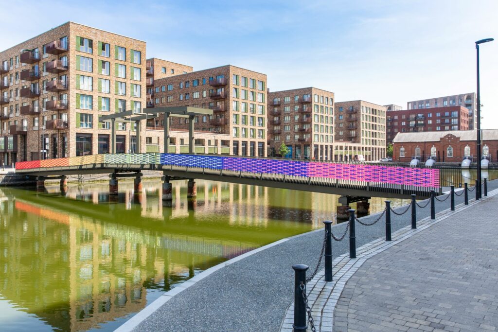 Royal Albert Wharf bridge with a woven rainbow on