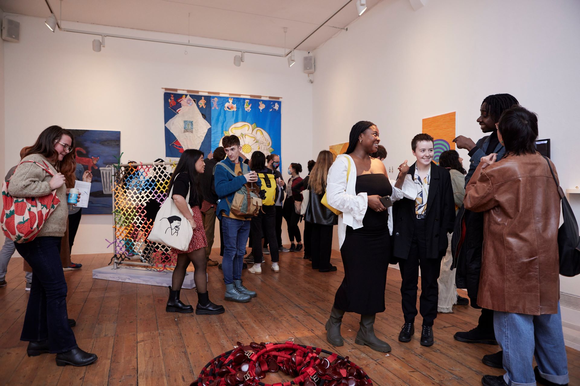People mingle in the Nunnery Gallery surrounded by artwork