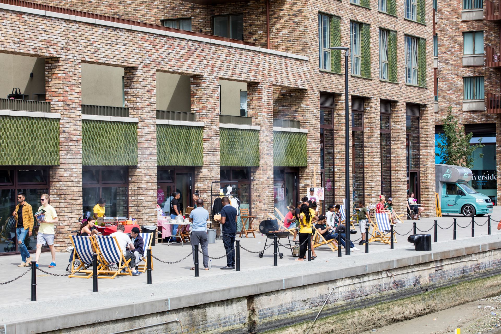 People sit and mingle outside of our RAW studios