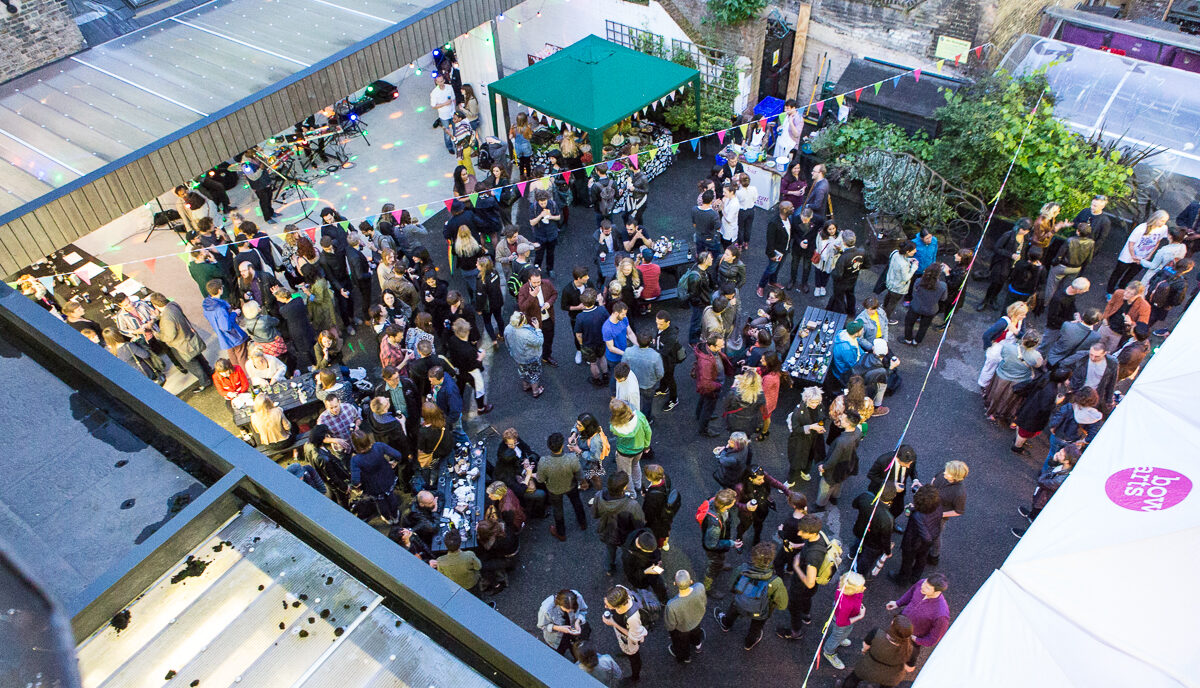 An above shot of a crowd mingling and talking in the courtyard