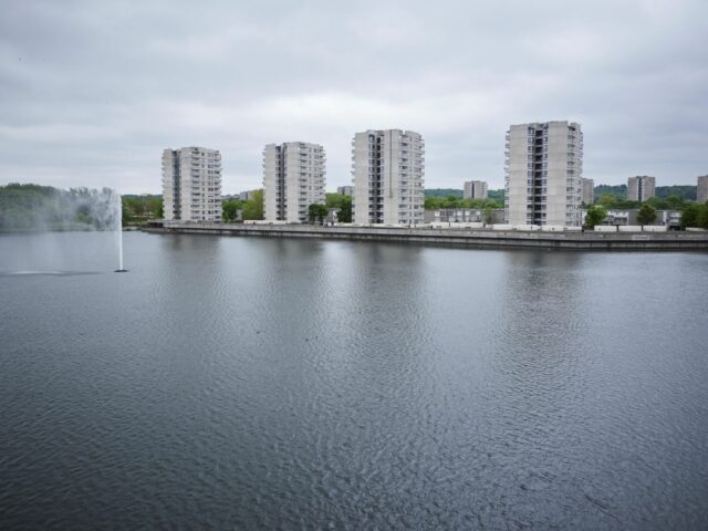 Southmere Lake with four brutalist buildings on the other side
