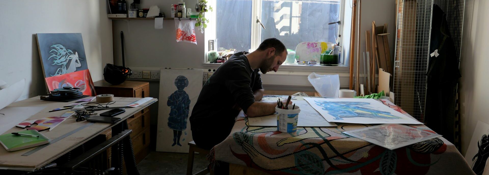 An artist draws in his studio