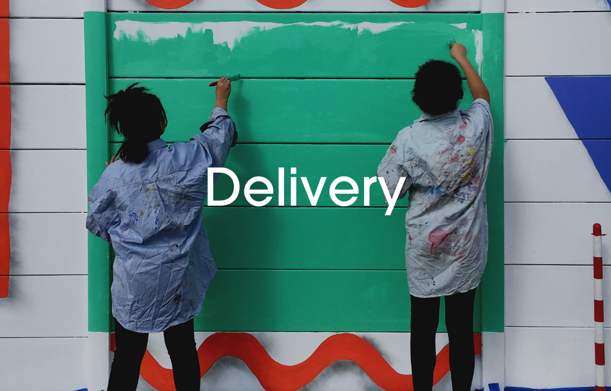 Students paint a fence, Delivery is written over the image