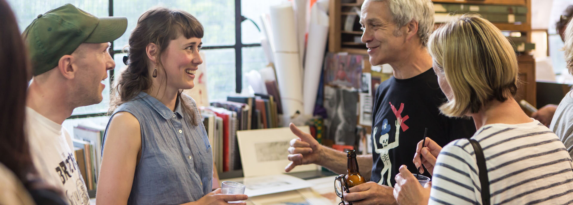 People talk in an artist's studio