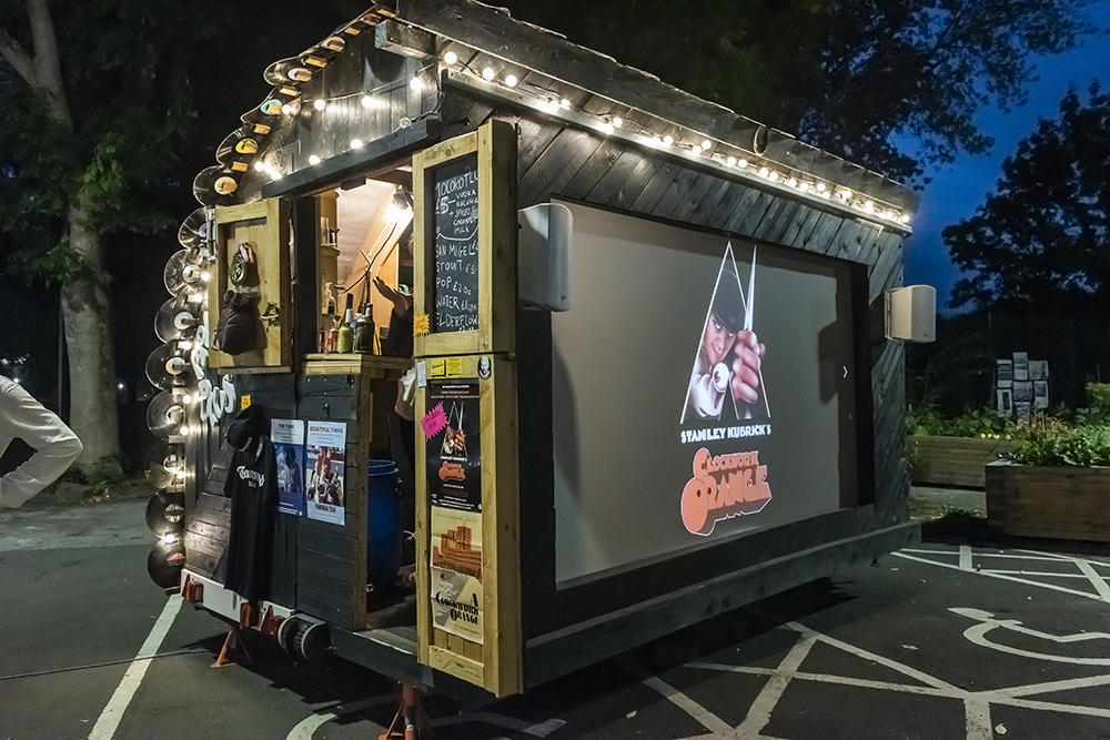 A film screen on the side of a bar