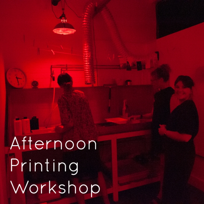 Three people in a darkroom, text reads Afternoon printing workshop