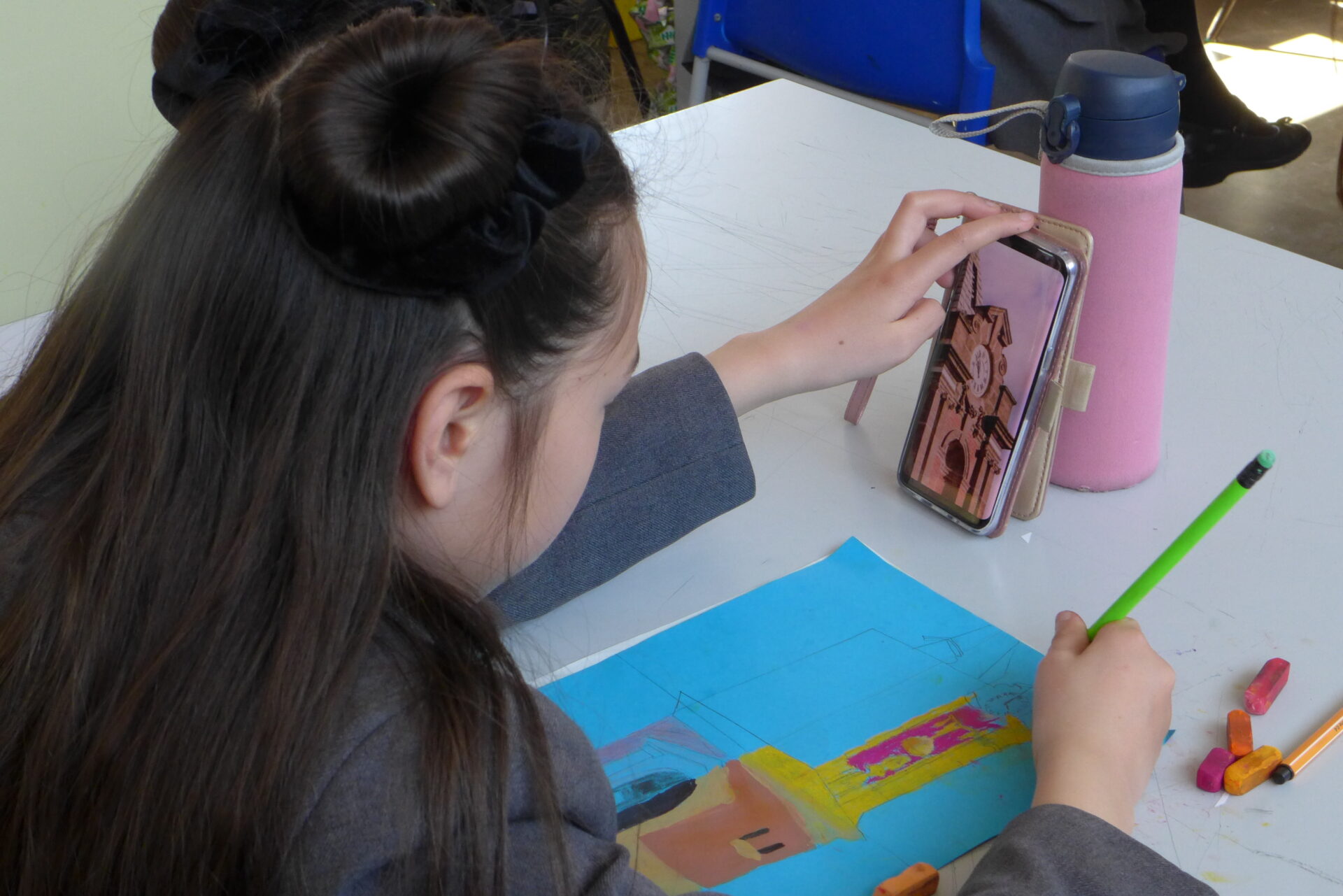 A student draws a clock tower