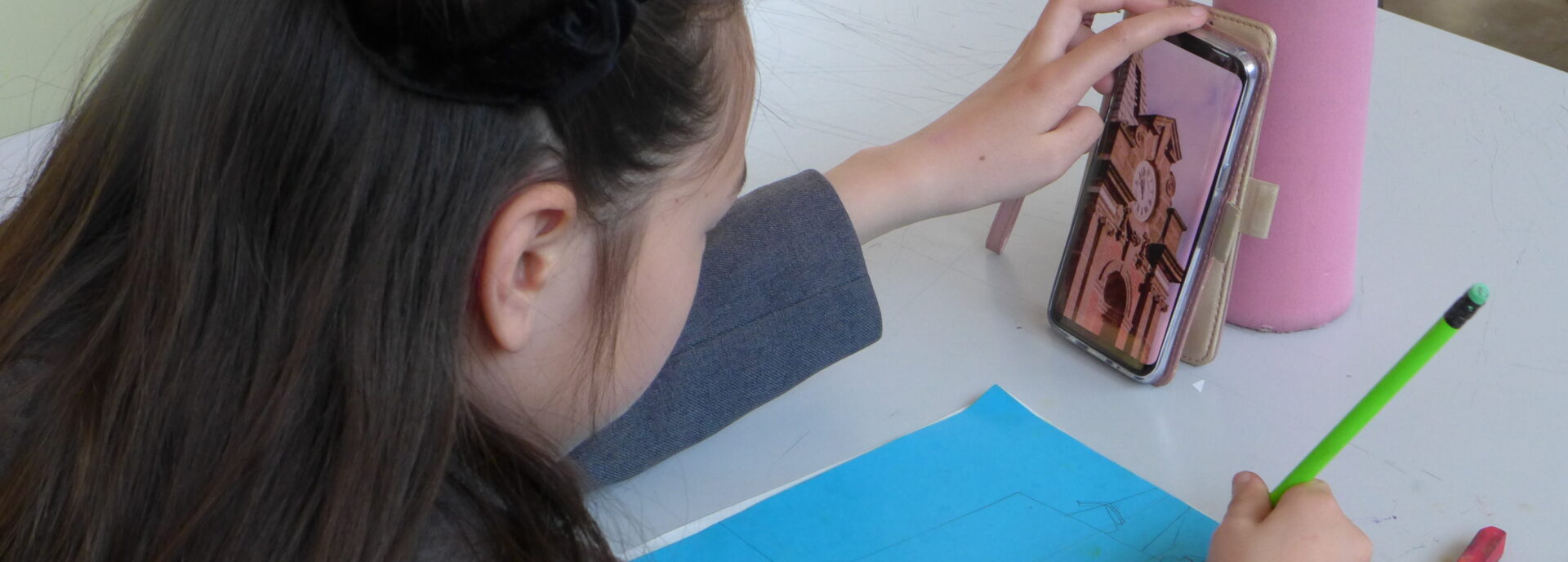 A student draws a clock tower