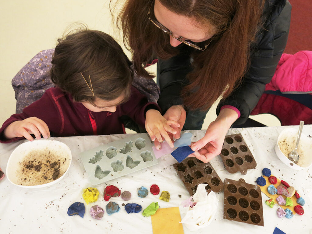 A child and parent participating in a workshop