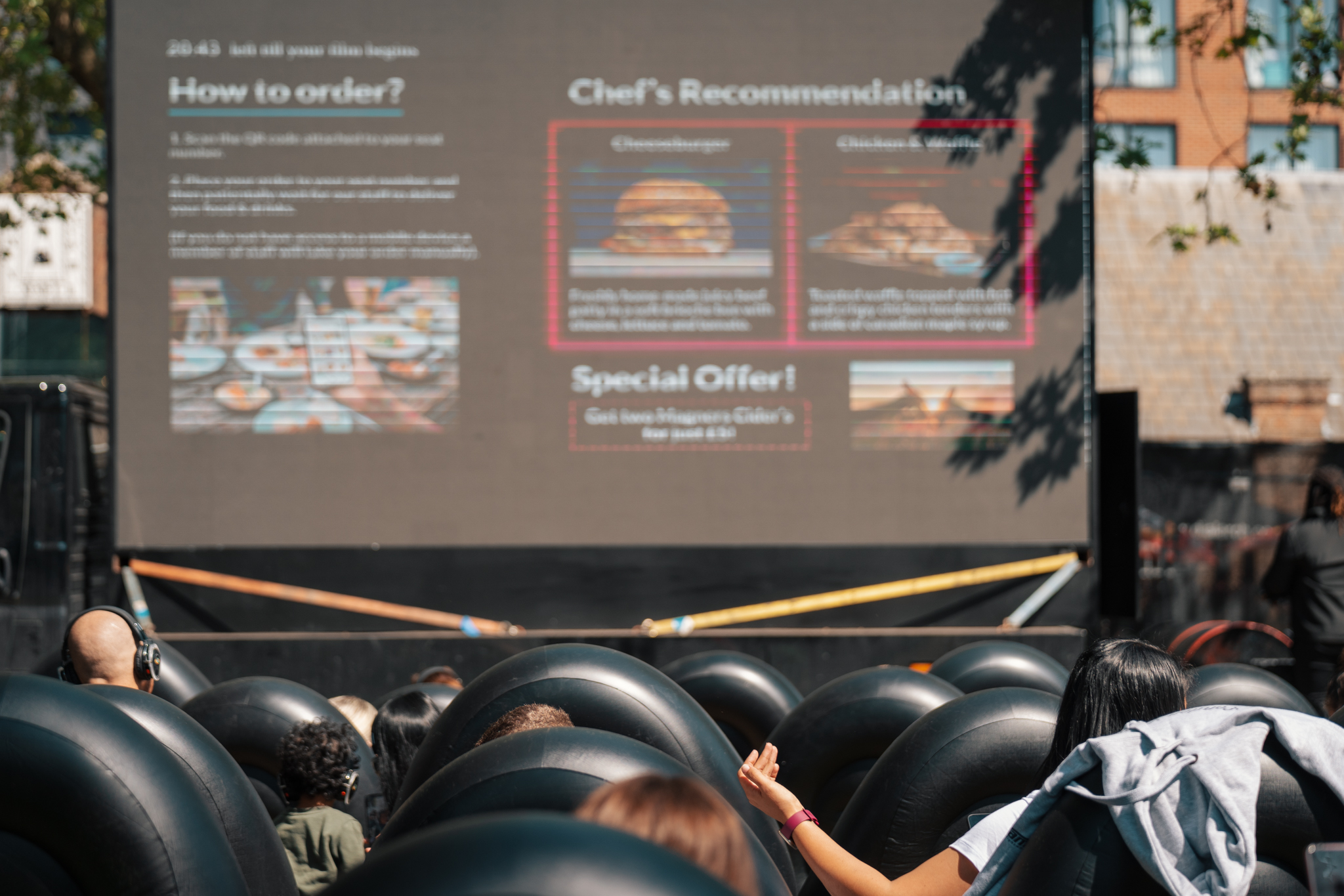 people watching outdoor cinema