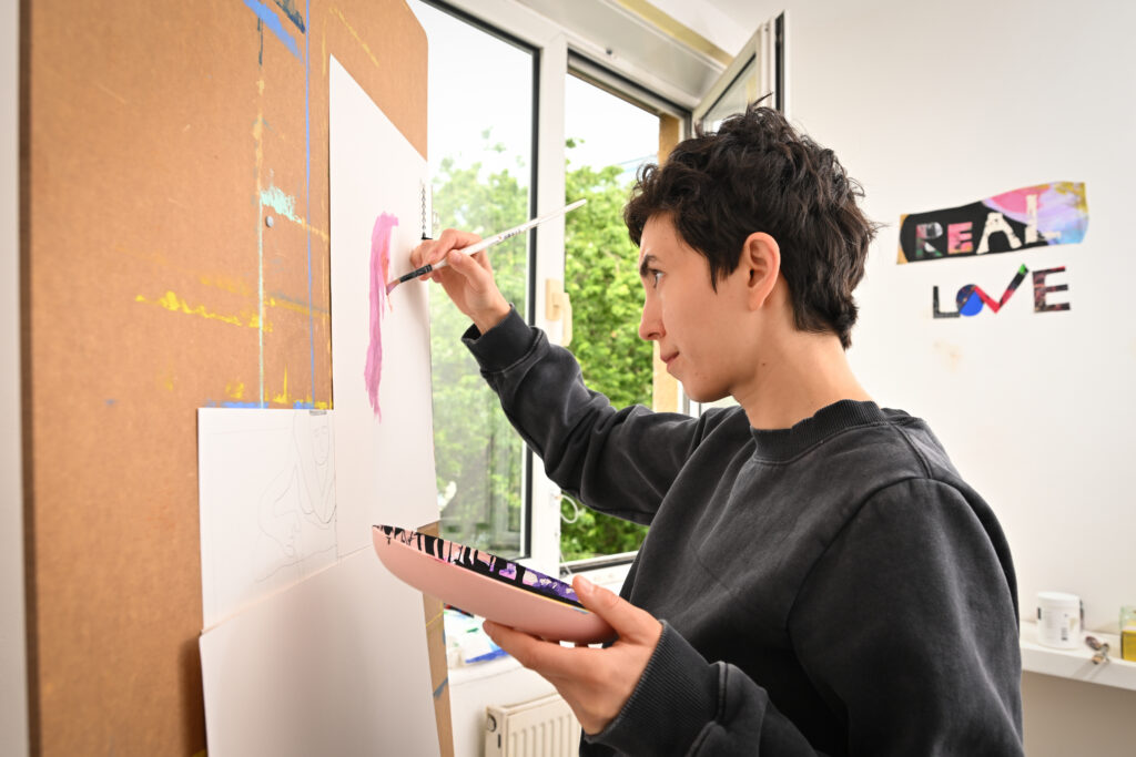 Artist Ioana paints in her studio