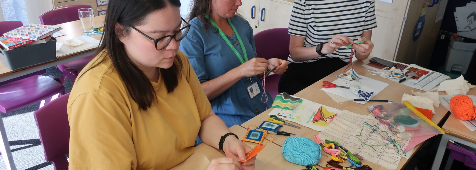 Teachers learning how to weave