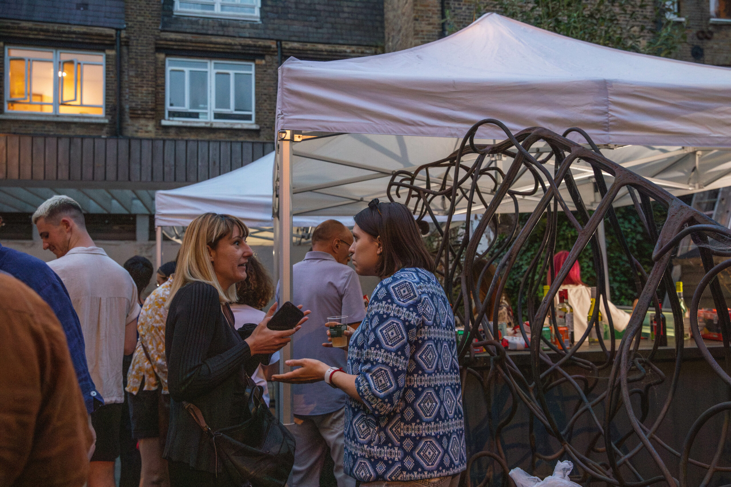 Two people in the Bow Arts Courtyard